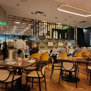 people sitting at tables in a restaurant