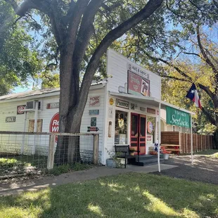 a small building with a large tree in front of it