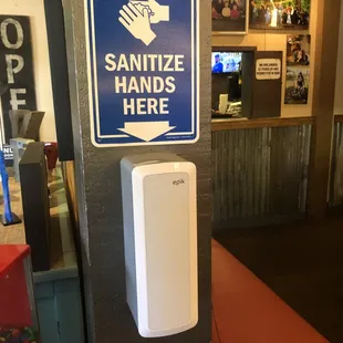 a hand sanitizer on the wall