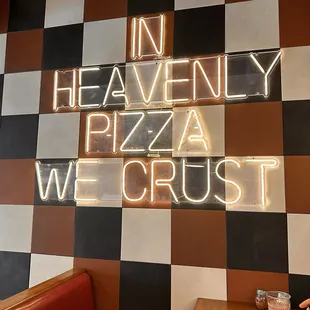 a neon sign that reads in heavenly pizza we crust