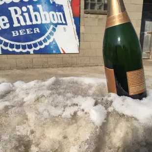 a bottle of blue ribbon beer in the snow
