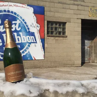 a bottle of champagne in the snow