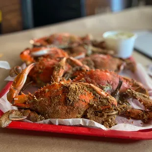 a tray of cooked crabs