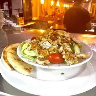 a bowl of salad and pita bread