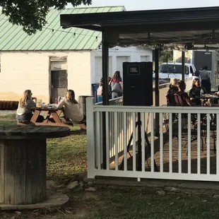 a group of people sitting at a picnic table