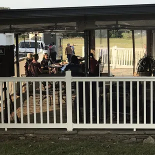 a group of people sitting on a porch