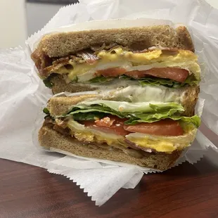 Bacon Egg and cheese sandwich with lettuce and tomato