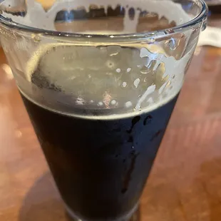 a glass of dark beer