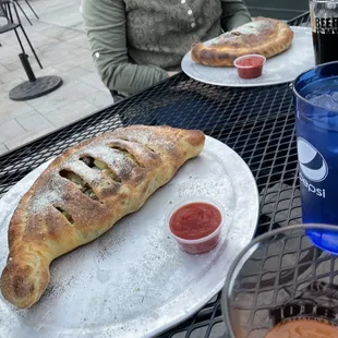a woman sitting at a table with a pastry