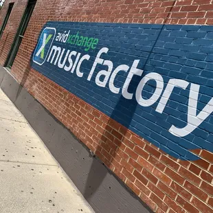 a brick building with a sign that says avidxchange music factory