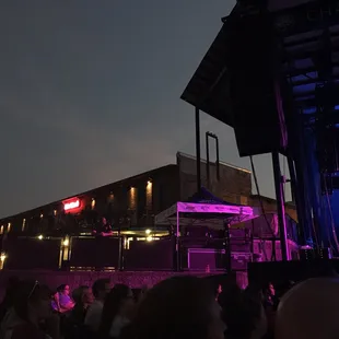 Vendors adjacent to the stage area. Industrial hip.