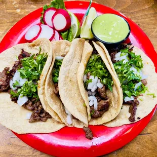 three tacos on a red plate