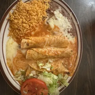 Three 3 Rolled Tacos with rice and beans
