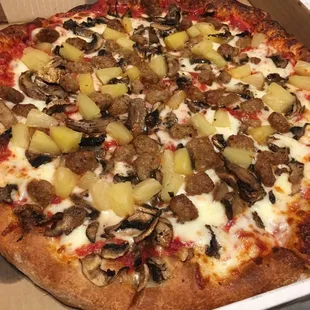 Medium sausage, pineapple, and mushroom pizza.