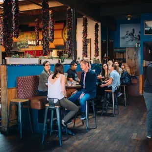 a group of people sitting at a bar