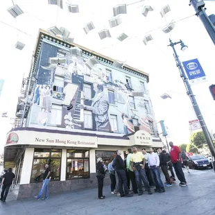 a group of people standing in front of a building