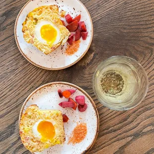 two plates of food and a glass of wine