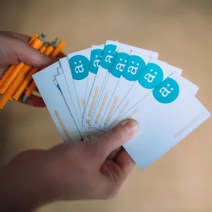 a person's hand holding a pack of tickets