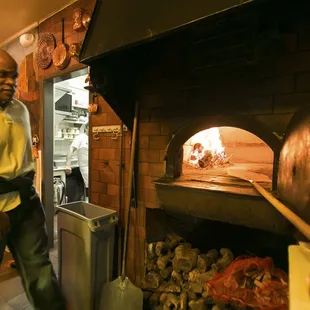 a man standing in front of an oven