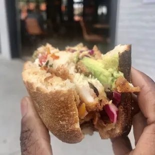 TORTA DE POLLO ($13)Fried chicken, bacon, cabbage, heirloom pico and avocado topped with avocado crema and queso freso