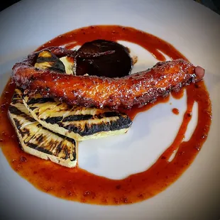 a plate of grilled meat and vegetables