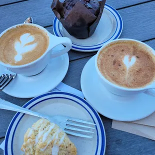 Lemon scone, chocolate muffin and decaf cappuccinos with extra foam and cinnamon