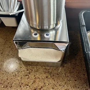 a stainless steel pot on top of a coffee roaster