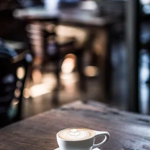 a cappuccino on a wooden table