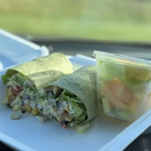 Spicy bacon chicken ranch wrap with fruit.
