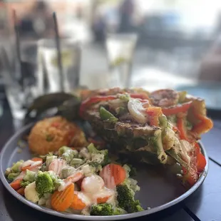 Grilled and stuffed Pineapple with veggies and queso.