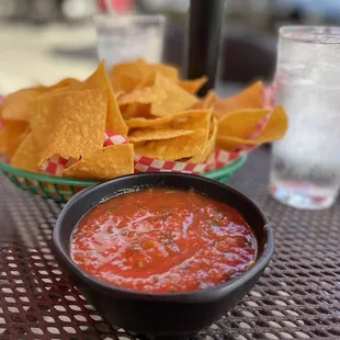 a bowl of salsa and chips