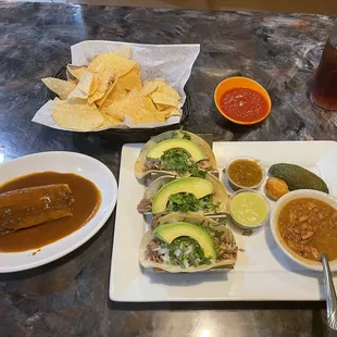 Tamale and soft corn tortilla carnita tacos.