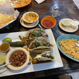Carne Assad Tacos with a side of rice smothered in queso.