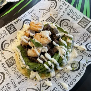 Avo-Crunch surf and turf loaded with avocado on top of a delicious crunchy arepa and drizzled with an amazing flavorful garlic aioli