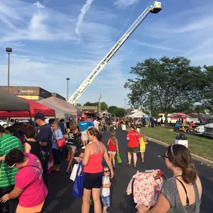 a crowd of people walking down the street