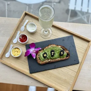 Bougie Toasty - avotoast, hackleback caviar, 24k gold flake, chives, egg yolk, crème fraîche, sweet hot pepper, complimentary sparkling wine