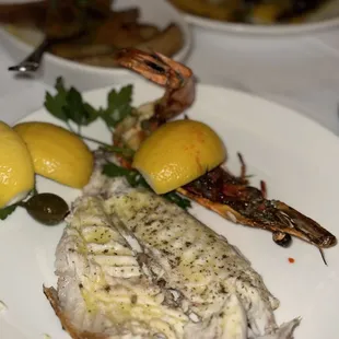 a plate of fish and lemons