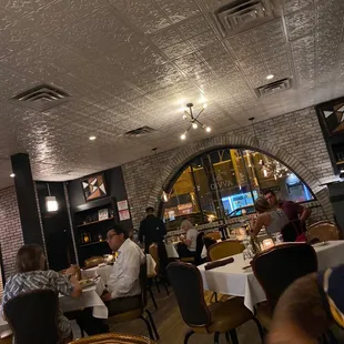 people sitting at tables in a restaurant