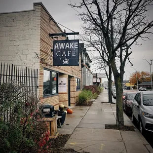 a sidewalk with parked cars