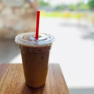 a cup of iced coffee on a table