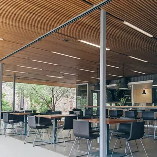 a view of a dining area with tables and chairs