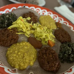 Two orders of 26. Vegan Combo with a plate of  Injera.