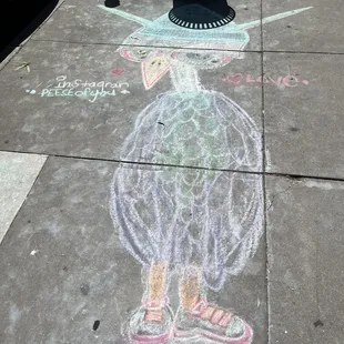 a chalk drawing of a bird on the sidewalk