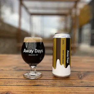 a glass of beer next to a can of beer