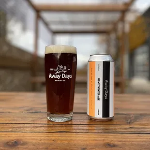 a glass of beer and a can of beer