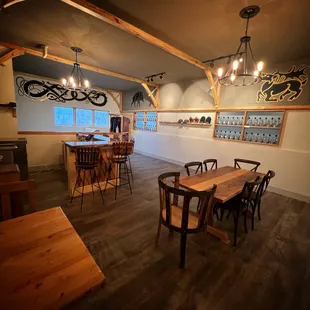 a dining room with wooden tables and chairs