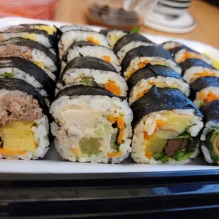 a plate of sushi rolls