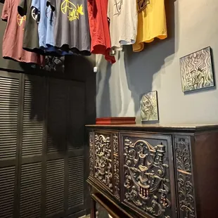a variety of t - shirts hanging on a clothes rack