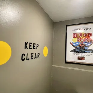 a poster on the wall of a bathroom