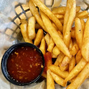 a basket of french fries with ketchup